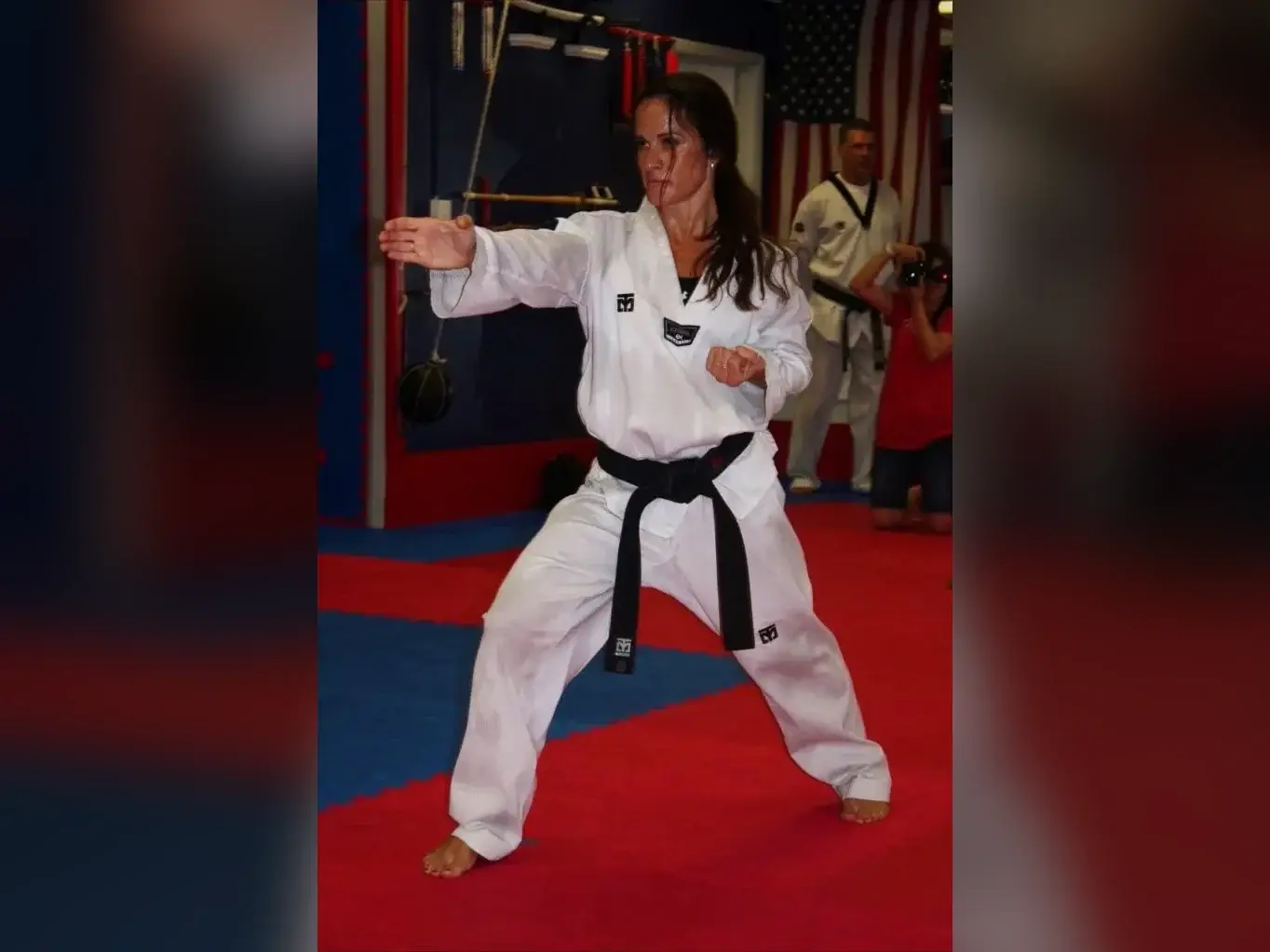 Adult black belt in a fighting stance, full body
