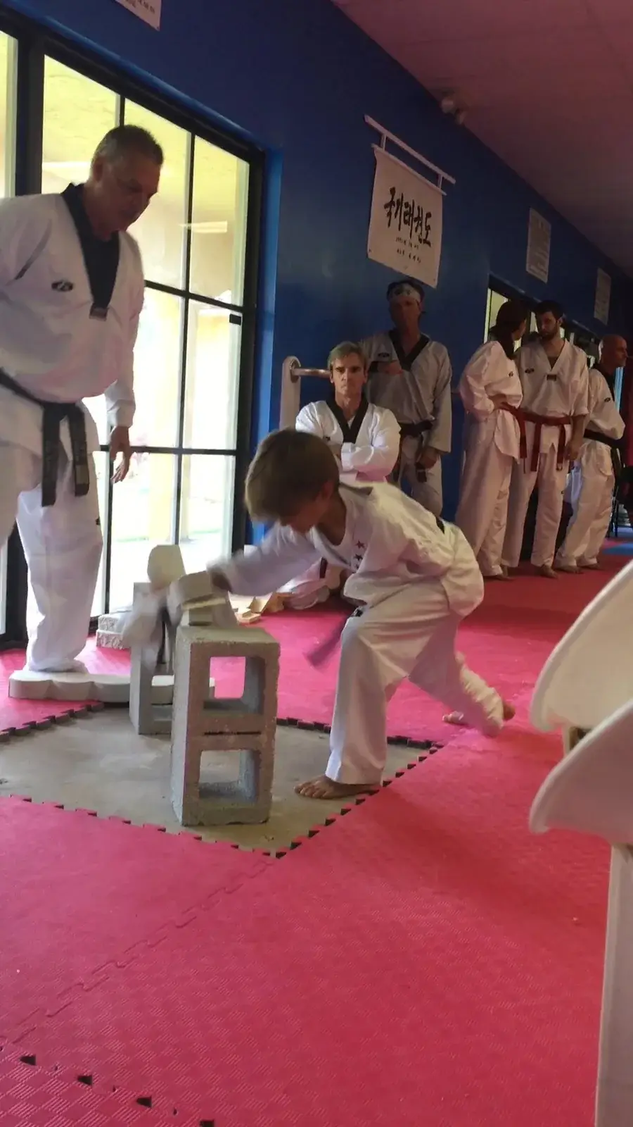 Student breaking a board during a class demonstration