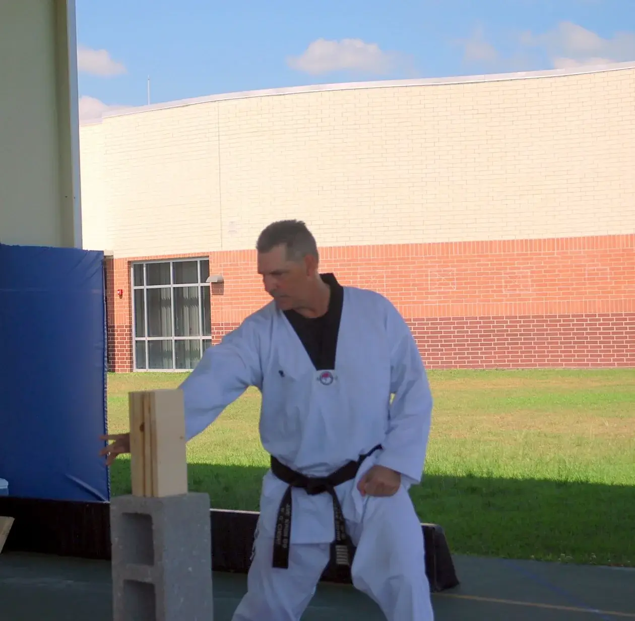 Instructor demonstrating a board break outdoors