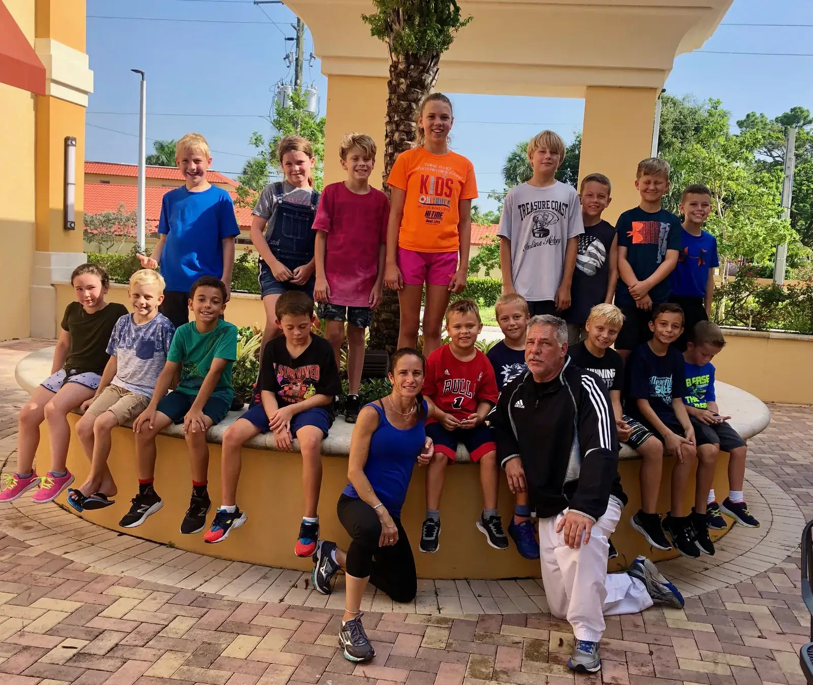 Children posing together outside during a school break camp