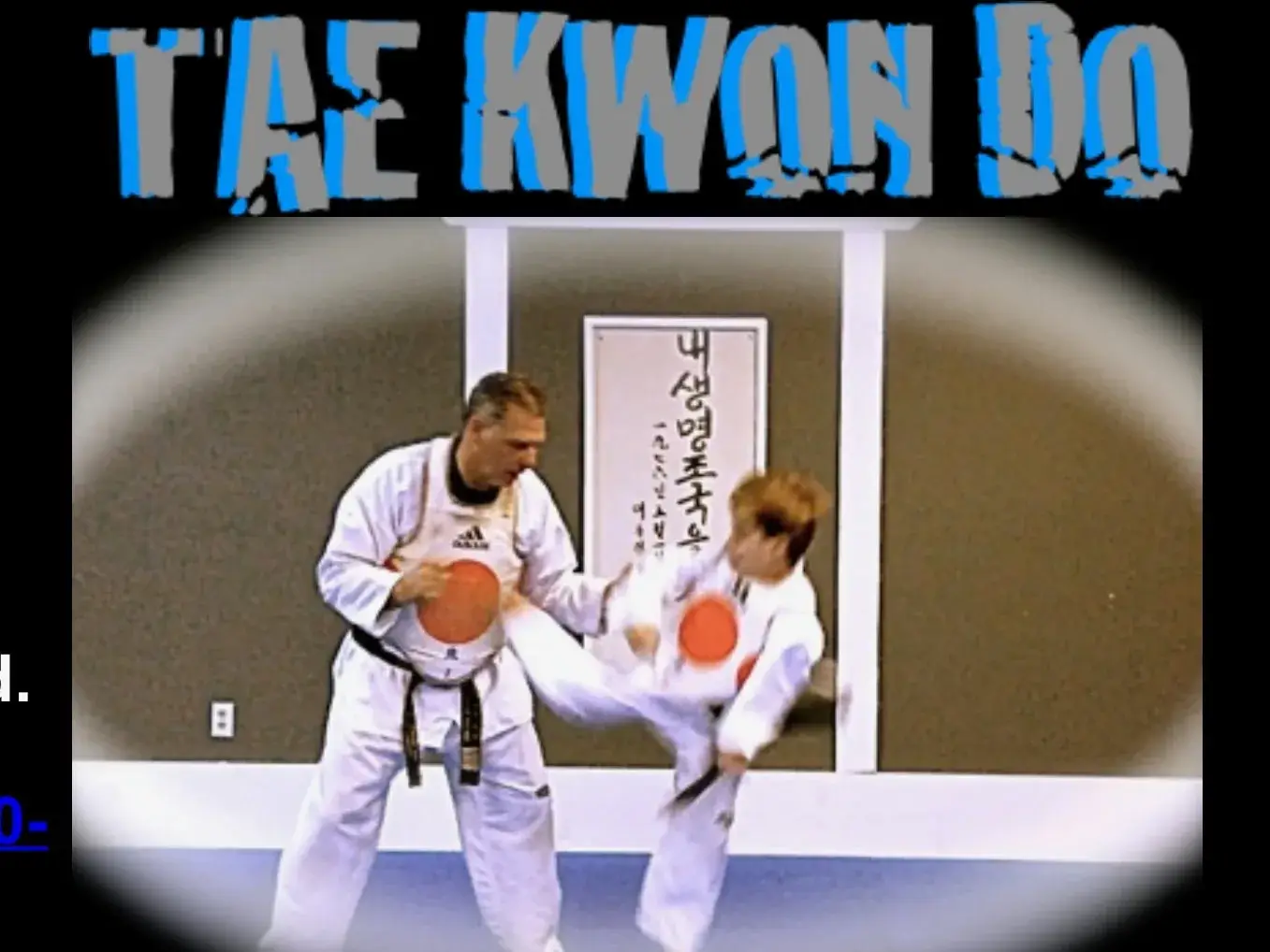 Old photo of two students sparring during an early Taekwondo class
